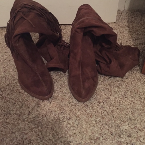 Brown high heeled boots with fringe