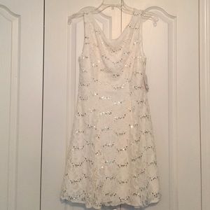Hi neck, low back. White lace dress.