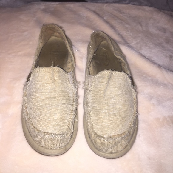 Tan sanuks with silver glitter stitching within