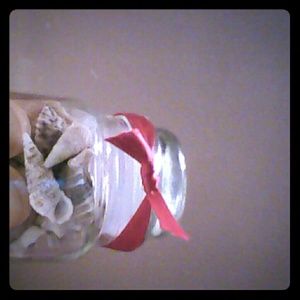 Glass jar with shells in it