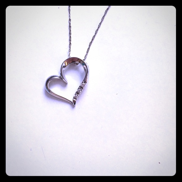 White gold heart necklace with three diamonds.