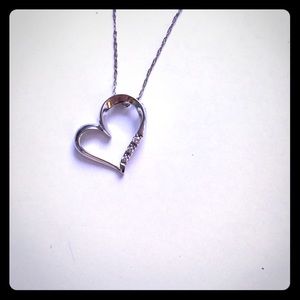 White gold heart necklace with three diamonds.
