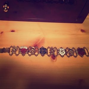 Gold Medieval crest and knights bracelet.