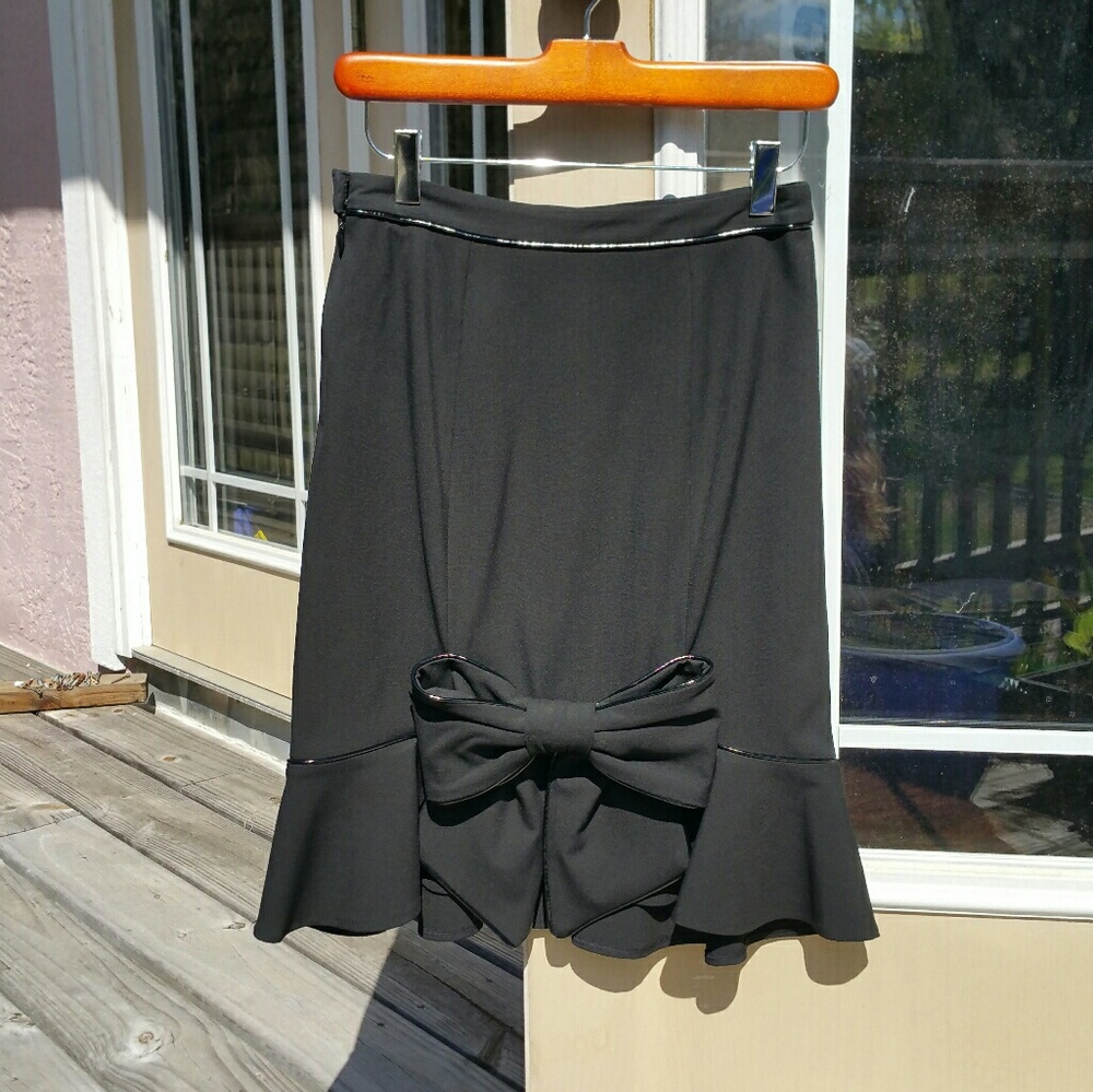 Betsey Johnson, knee length skirt w/ bow on back.
