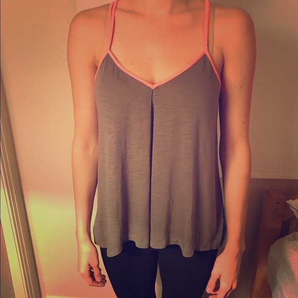 Green tank with pink detailing and a strappy back.
