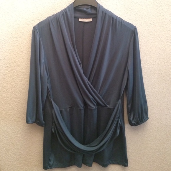 Cris-cross blouse in teal blue.