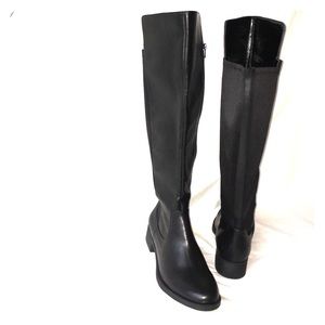 Knee high black leather boots.