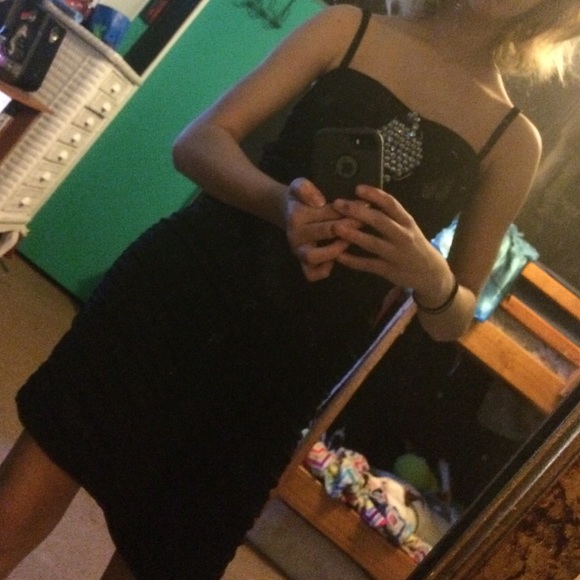 Black knee-length strapless dress.