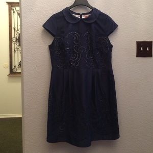 Navy blue dress with cream underlay.