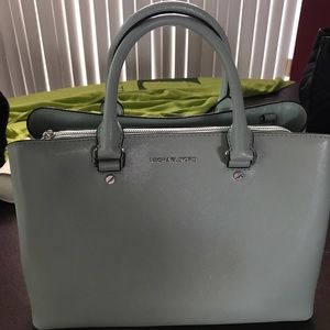 Sea foam green Michael Kors tore. Never used.