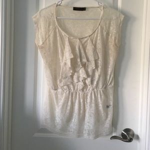Creme colored sheer blouse.