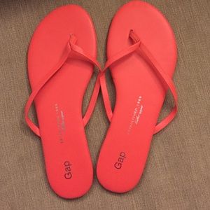 Bright coral leather flip flops