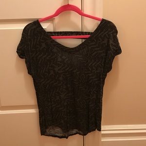 Short sleeve shirt with open low cut back.