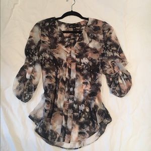 Sheer pull over blouse with 3/4 pull up sleeves.