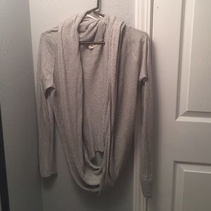 Gray sweater with cross body design.