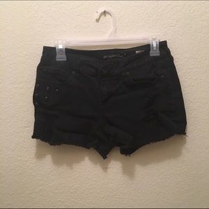 Black jean shorts with skull studs