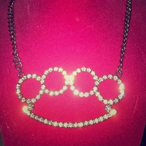 Brass knuckles with diamond accent necklace