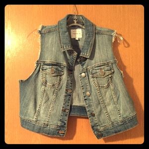 Crop top jean jacket with cut off sleeves.