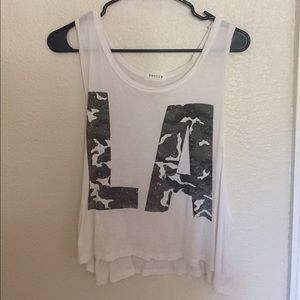 White low-arm cut tank top; camouflage writing
