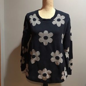 Navy blue sweater with white flowers.
