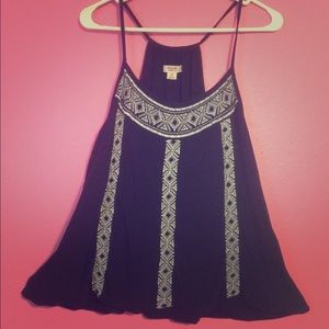 Black tank top with white patterned design.