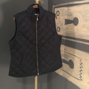 Navy puffer vest with gold zipper
