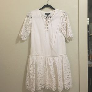 White eyelet trimmed dress with lace up v neck