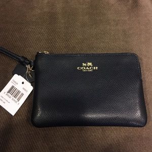 Brand new, never used Coach navy blue wristlet
