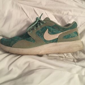 Blue and white Nike roshes