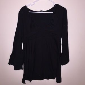 Black blouse with deep v-neck and empire waist.