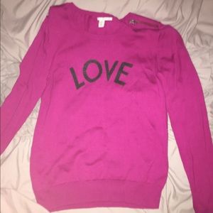 Magenta sweater with the word "love" on the front