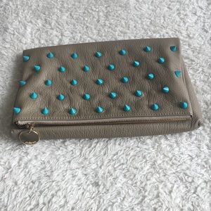 Vegan leather foldover clutch with spike studs