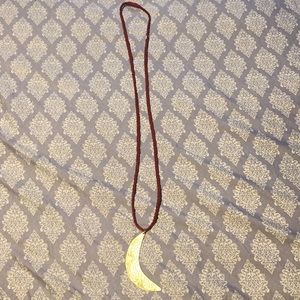 Gold moon necklace.