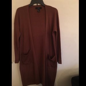 Burnt orange cardigan.