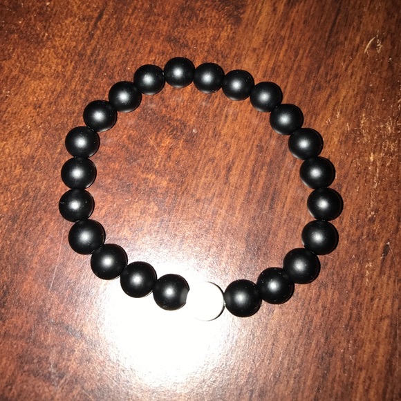 Black beaded bracelet with white marble bead.