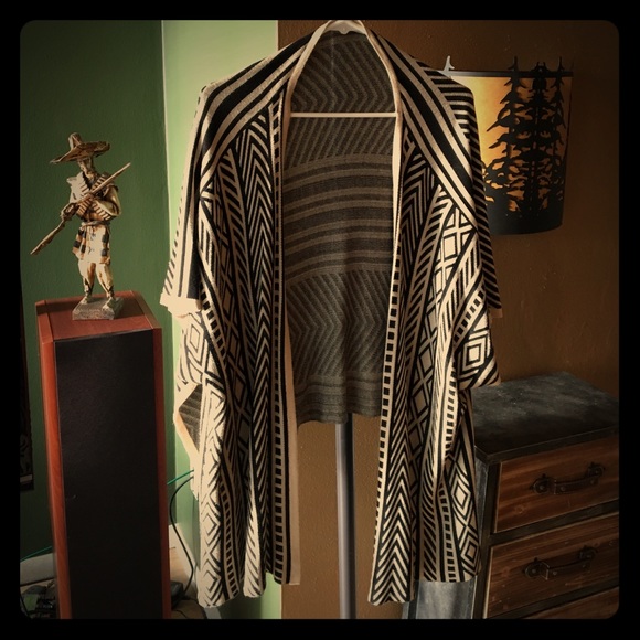 Lightweight wrap with sleeves that hang.