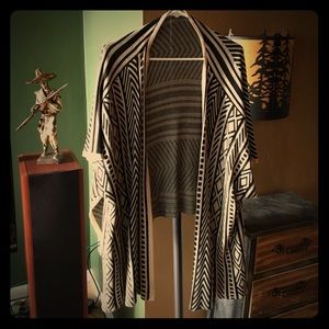 Lightweight wrap with sleeves that hang.