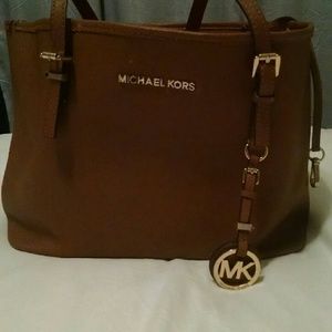 Michael Kors brown bucket bag, marked and worn.