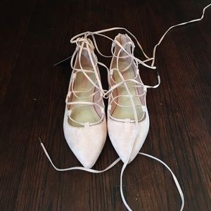 Pink lace up flats.