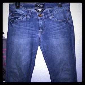 Low rise boot cut lucky jeans.