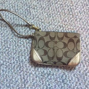 Brown and gold coach wristlet