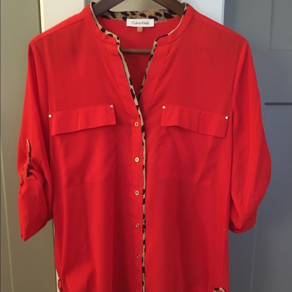 Calvin Klein orange blouse with leopard detail.