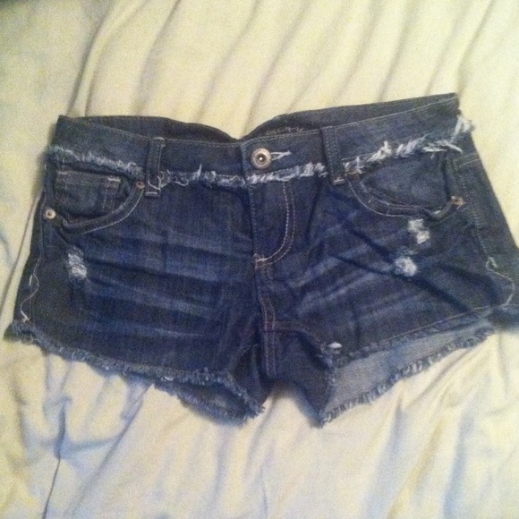 Medium/dark wash distressed denim shorts