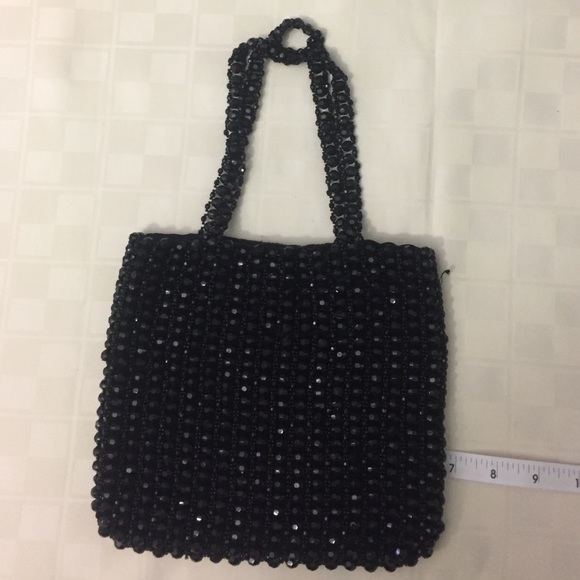 Black beaded bag with satin lining.