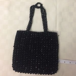 Black beaded bag with satin lining.