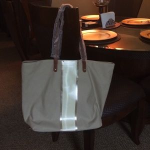 Brand new, tan purse. Comes with change purse.