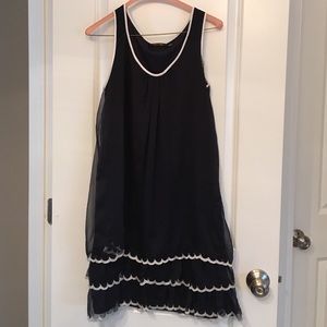 Sheer layered navy dress with white details.