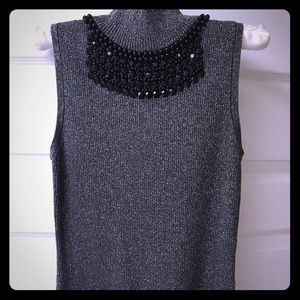 Sparkly sleeveless sweater with beaded neckline.
