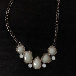 White and gold stone necklace.