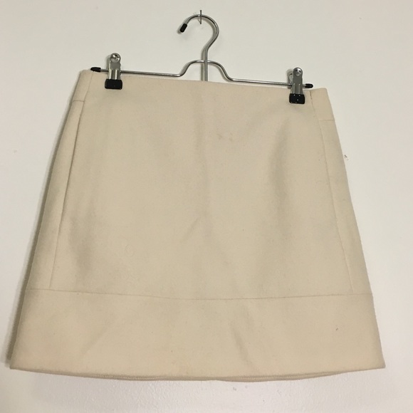 A cream wool skirt.